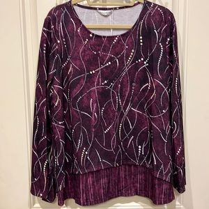 Shirt is Plum and purple colors with white accents